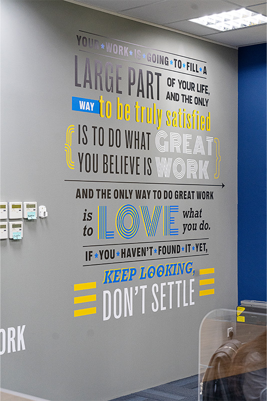 Motivational Quote about Great Work and Love on wall at FirstCom Solutions Singapore office 