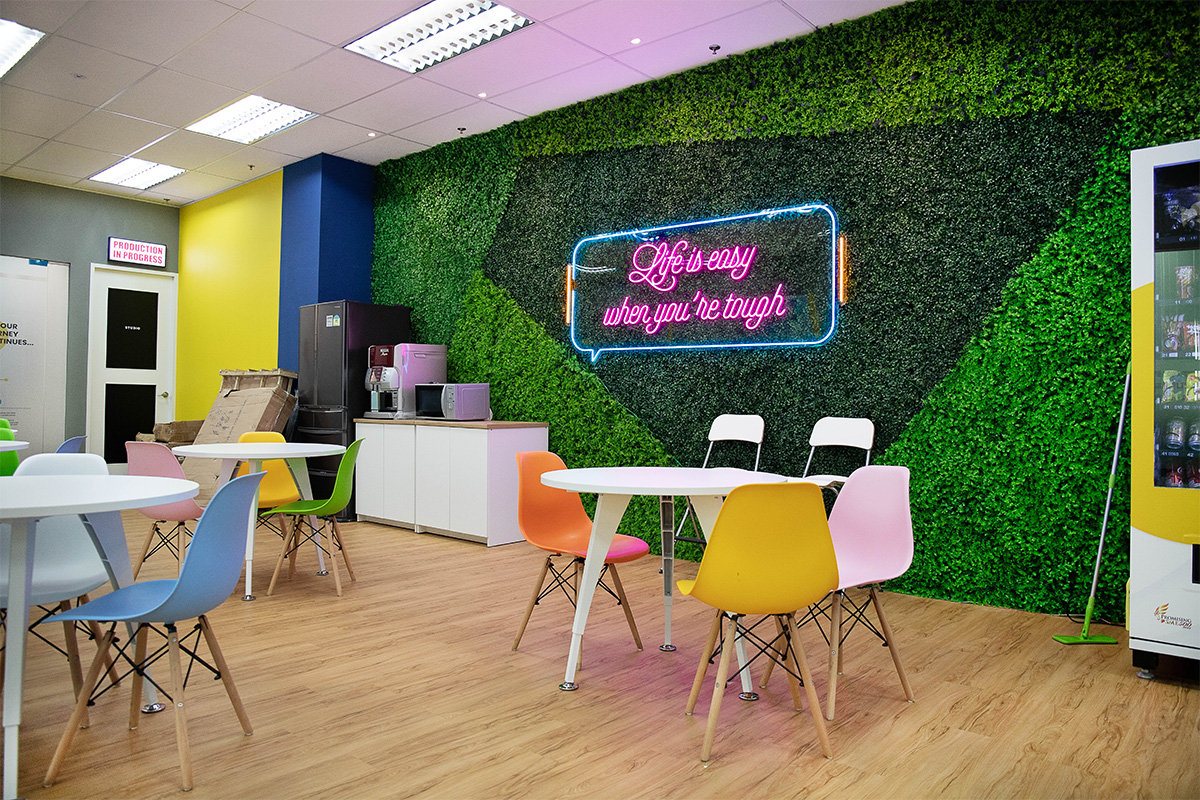 Well-designed staff pantry area, with Life is easy when you are tough neon signboard